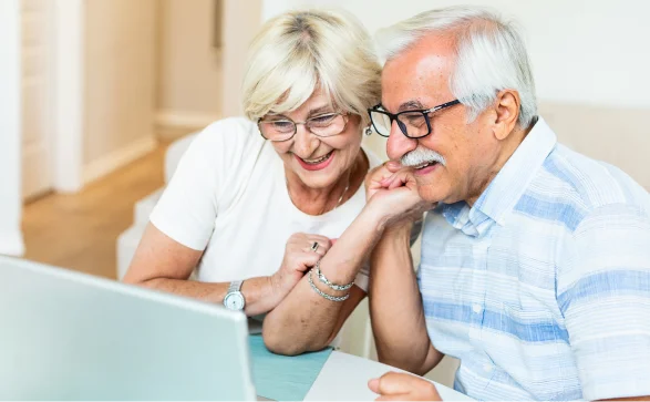 Elderly couple watching a laptop
